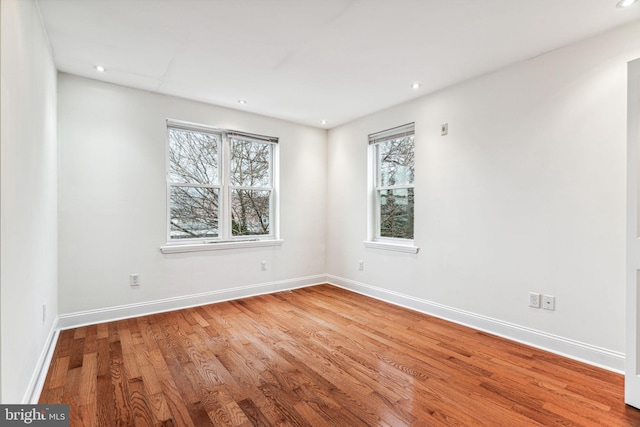 unfurnished room featuring hardwood / wood-style flooring