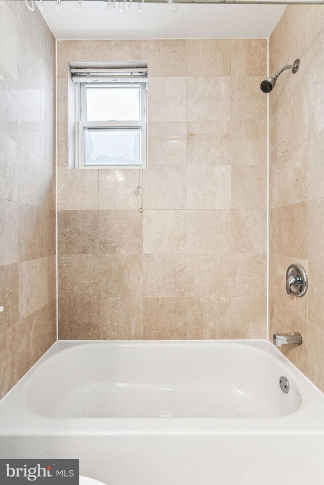 bathroom featuring tiled shower / bath