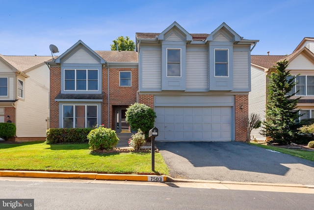 view of front of home with a garage and a front yard