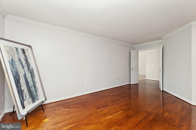 spare room featuring crown molding and dark hardwood / wood-style flooring