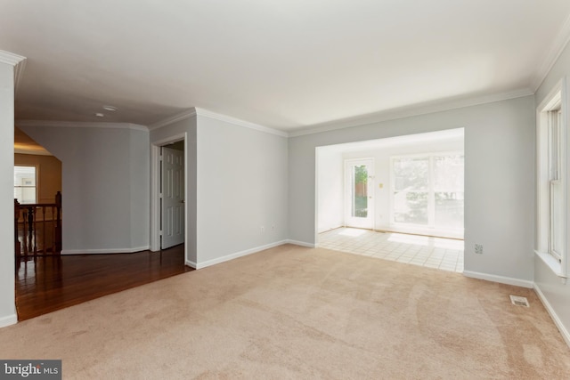 unfurnished room featuring crown molding and light colored carpet