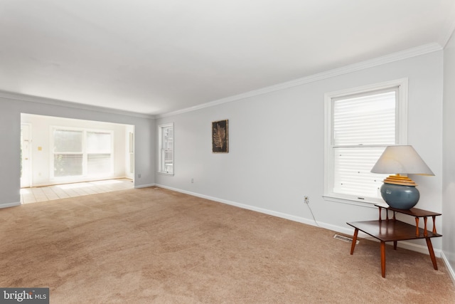 interior space with crown molding, a healthy amount of sunlight, and light colored carpet