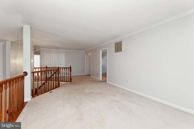 carpeted spare room with crown molding