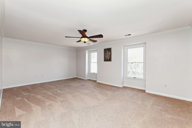 carpeted empty room with plenty of natural light, ornamental molding, and ceiling fan