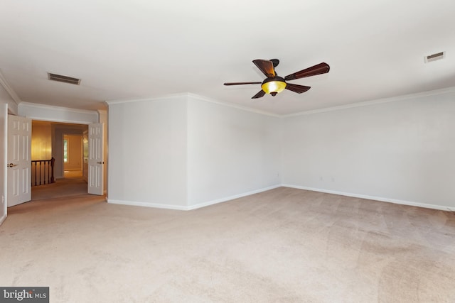 empty room with light carpet, crown molding, and ceiling fan