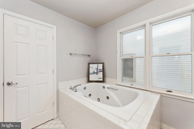 bathroom featuring tiled bath and tile patterned flooring