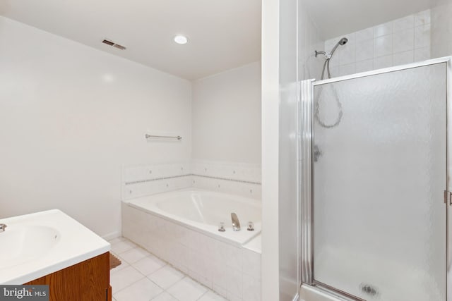 bathroom with vanity, tile patterned floors, and plus walk in shower