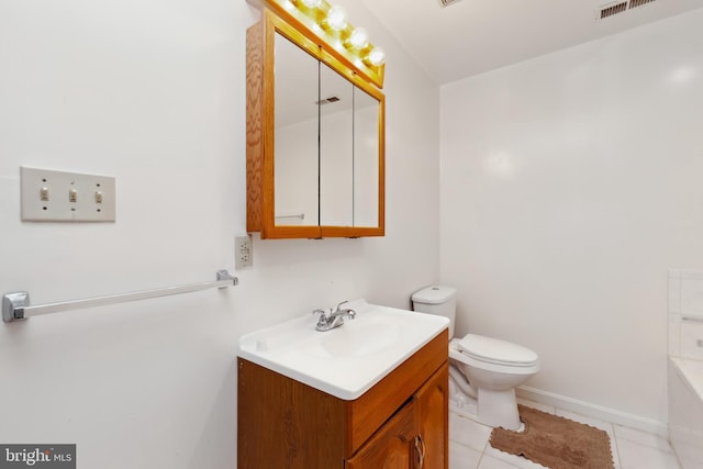 bathroom featuring vanity, tile patterned floors, and toilet