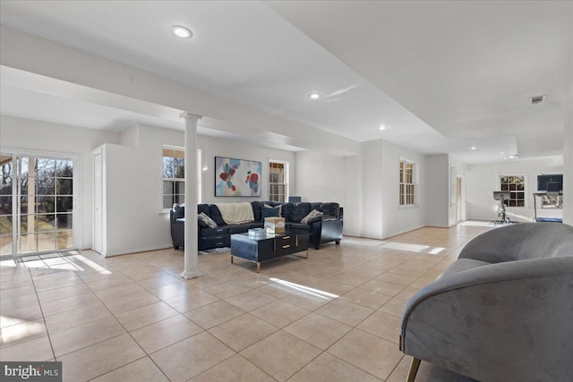 living room with light tile patterned floors and decorative columns