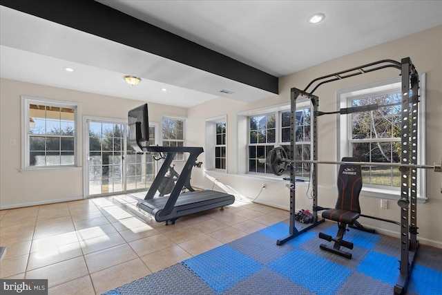 workout room featuring light tile patterned floors