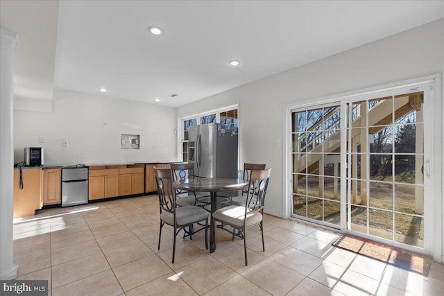 dining space with light tile patterned flooring and a wealth of natural light