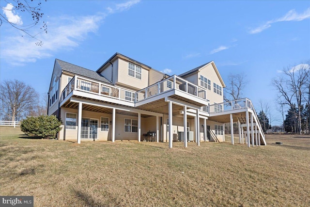 rear view of property with a yard and a wooden deck