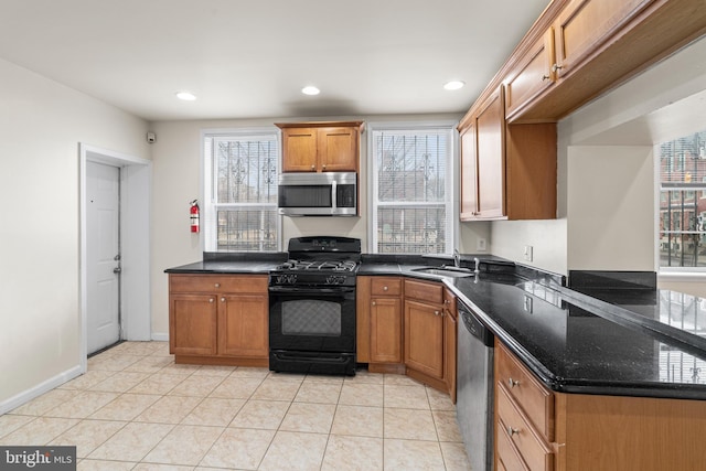 kitchen featuring light tile patterned floors, appliances with stainless steel finishes, brown cabinets, a sink, and recessed lighting