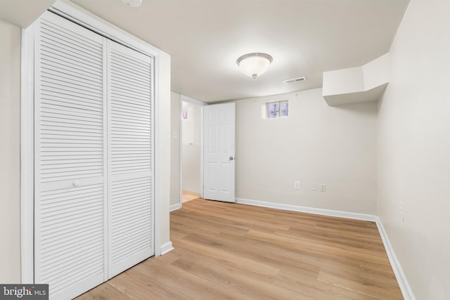 interior space with light wood finished floors, visible vents, and baseboards