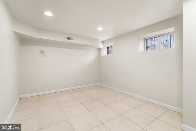 basement featuring recessed lighting, visible vents, baseboards, and light tile patterned floors