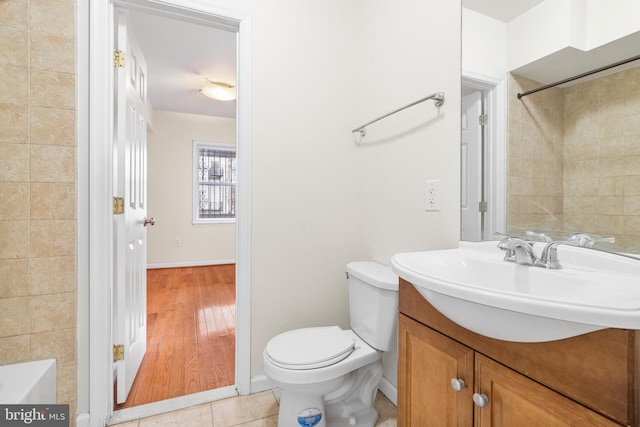 bathroom with toilet, vanity, a bath, tile patterned floors, and walk in shower