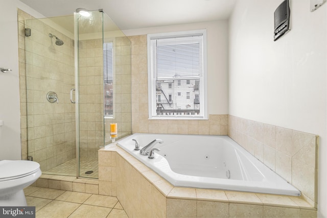 full bath with tile patterned flooring, a jetted tub, a shower stall, and toilet