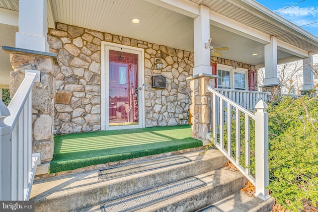 doorway to property with ceiling fan and covered porch