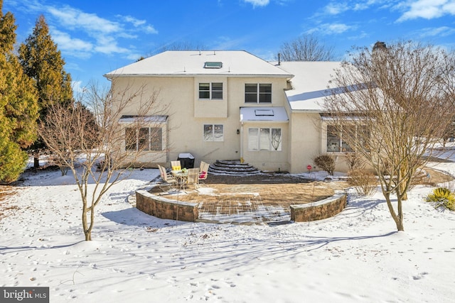 view of snow covered rear of property