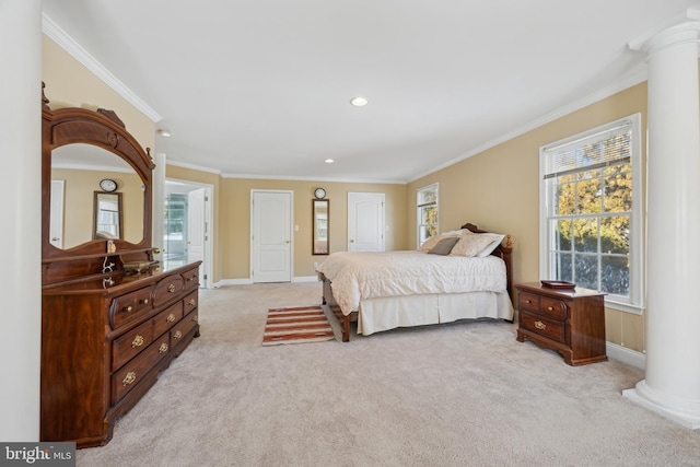 carpeted bedroom with ornate columns and ornamental molding