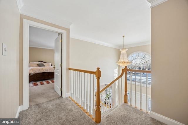 corridor featuring light colored carpet, ornamental molding, and a chandelier