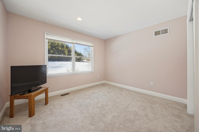 unfurnished room with light carpet