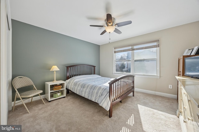 bedroom featuring light colored carpet and ceiling fan