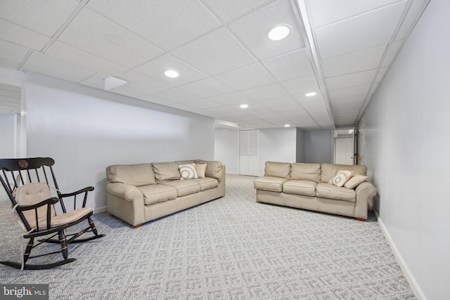 living room featuring light colored carpet and a drop ceiling