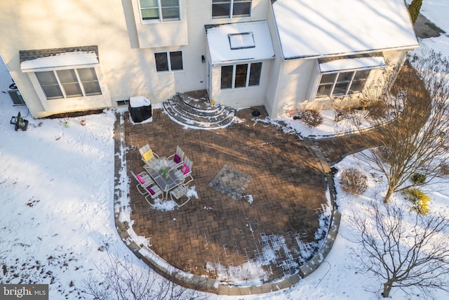 view of snow covered rear of property