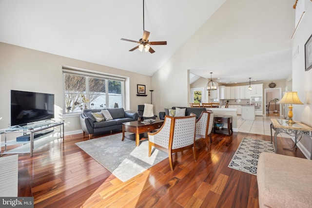 living room featuring hardwood / wood-style floors, a wealth of natural light, and high vaulted ceiling