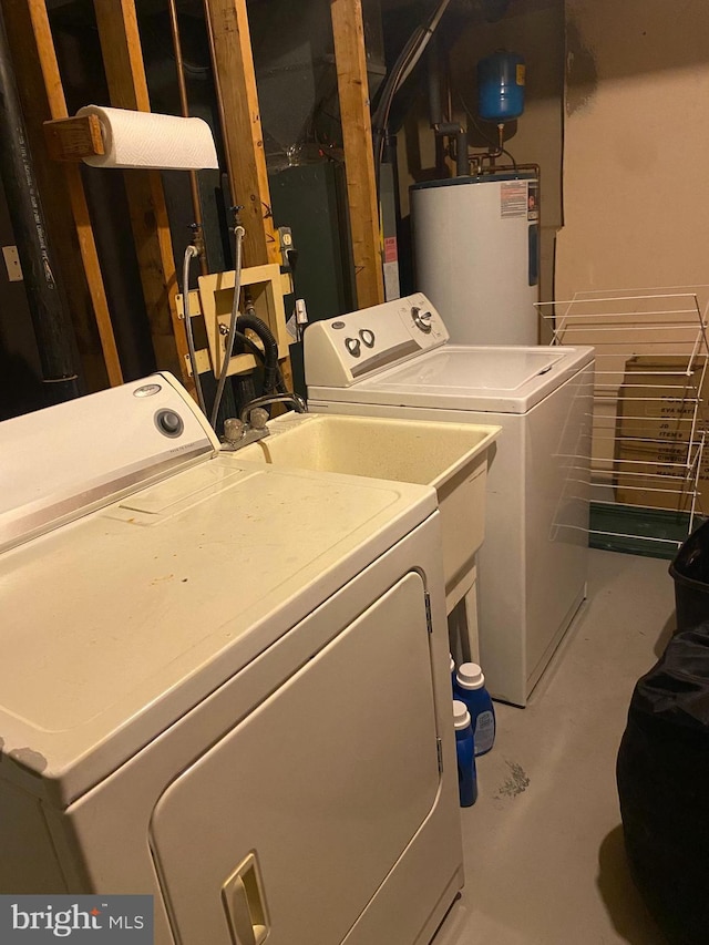 washroom featuring washing machine and clothes dryer and water heater