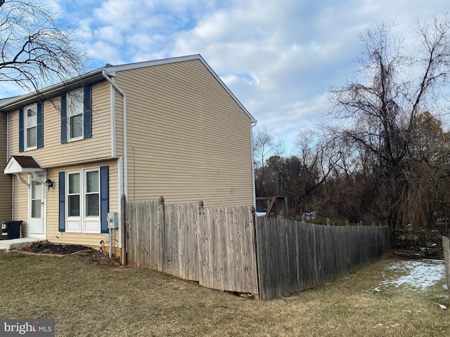 view of side of property with a lawn