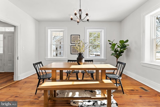 dining space featuring a chandelier and hardwood / wood-style floors