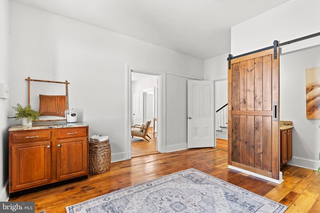 interior space featuring dark wood-type flooring and a barn door