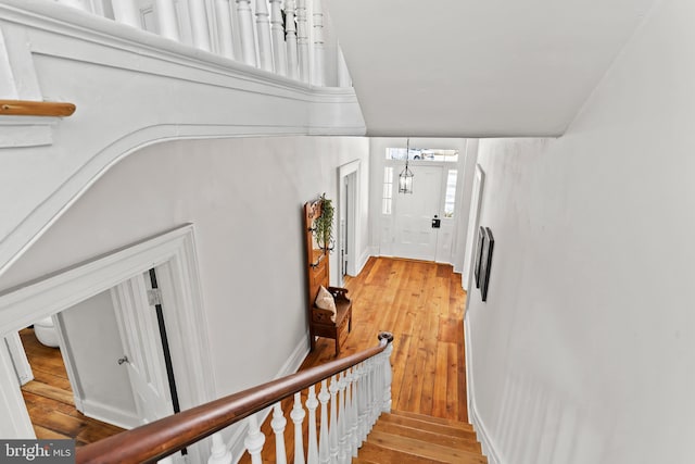 stairs featuring lofted ceiling and hardwood / wood-style floors