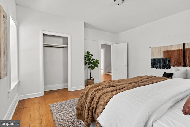 bedroom featuring a closet and light hardwood / wood-style flooring