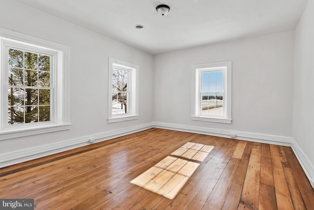 spare room featuring wood-type flooring