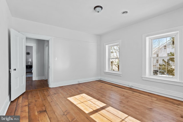 spare room featuring light hardwood / wood-style floors