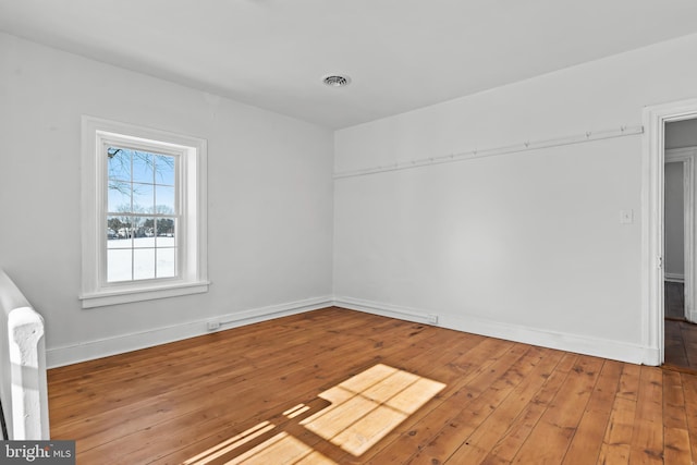 unfurnished room featuring hardwood / wood-style floors