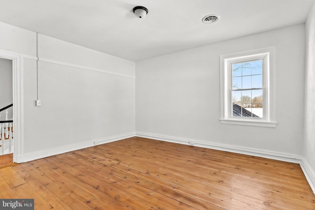 unfurnished room with light wood-type flooring