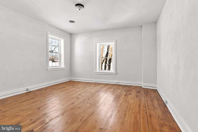 spare room with hardwood / wood-style floors