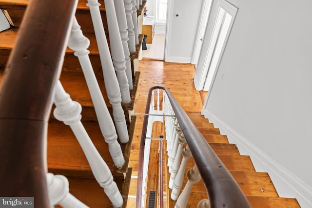 stairs with hardwood / wood-style flooring