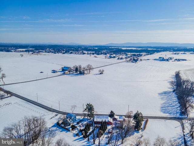 snowy aerial view with a mountain view