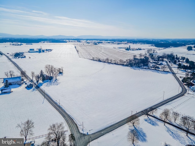 snowy aerial view with a mountain view