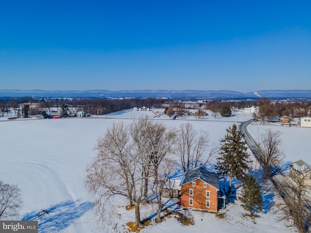 snowy aerial view featuring a mountain view