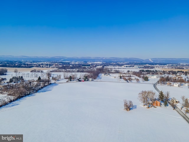 snowy aerial view with a mountain view