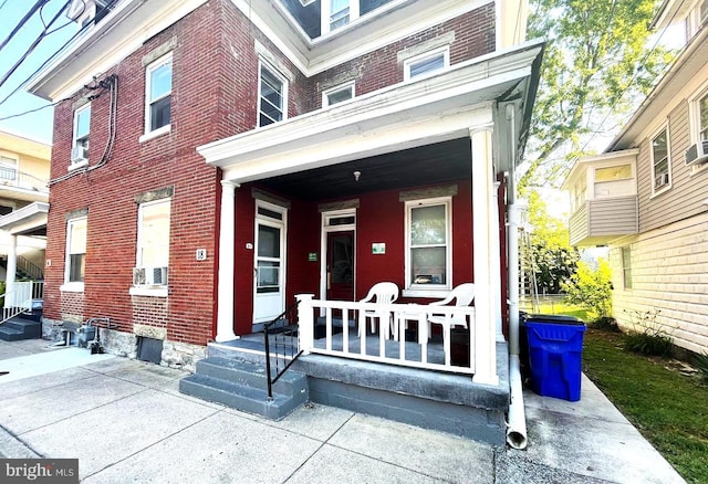 view of exterior entry with covered porch