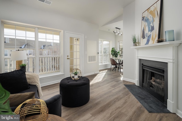 living room featuring vaulted ceiling and light hardwood / wood-style flooring