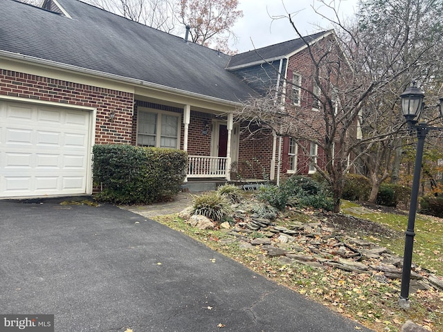 view of front facade featuring a garage and covered porch