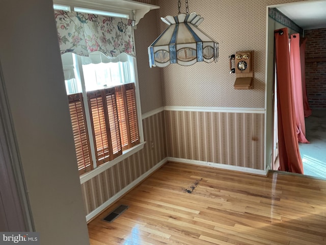 unfurnished dining area featuring hardwood / wood-style flooring